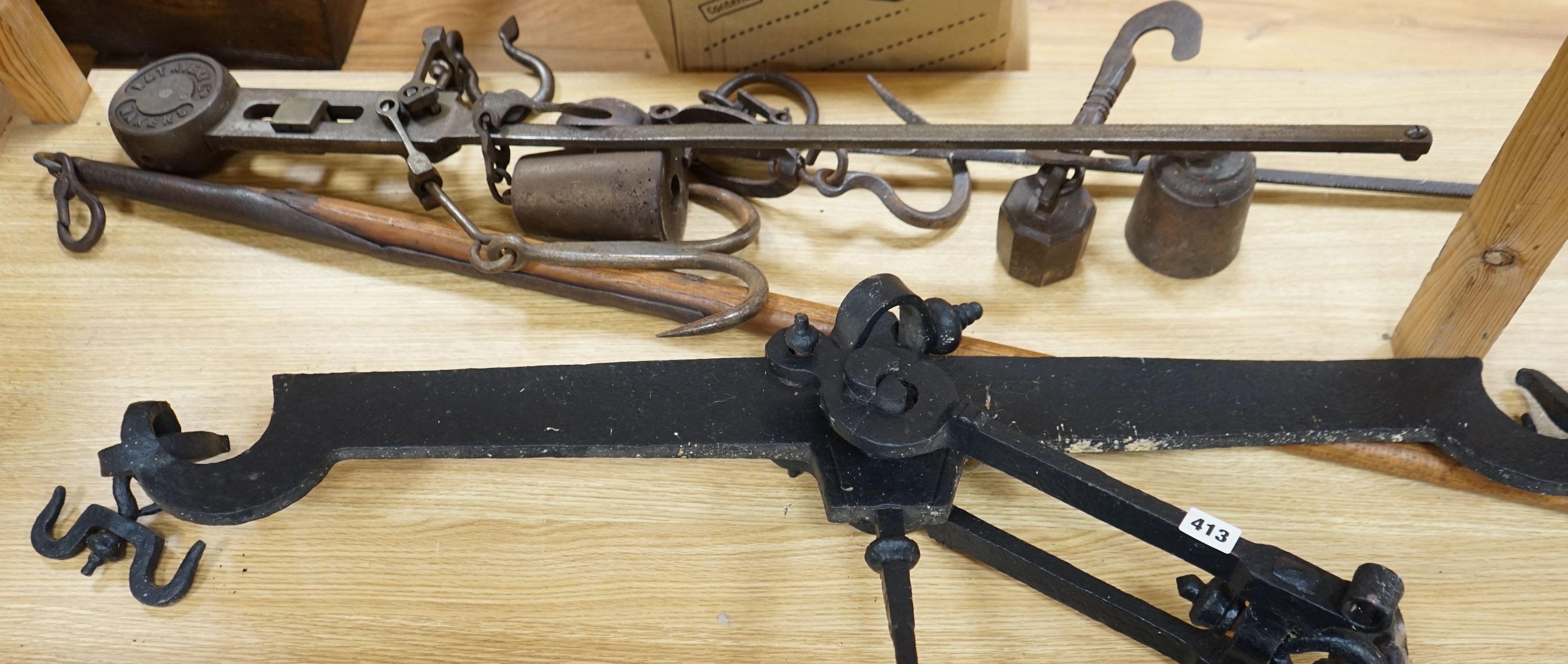 A large beam scale, brass scale: W &T Avery LTD and a similar cast iron scale, 103cm wide